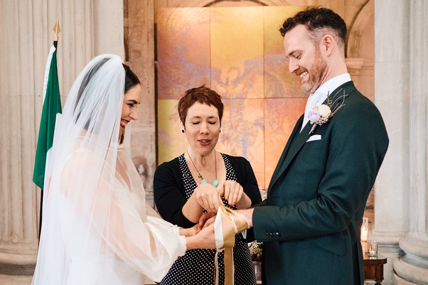A bride and groom do a handfasting ceremony at Dublin City Hall