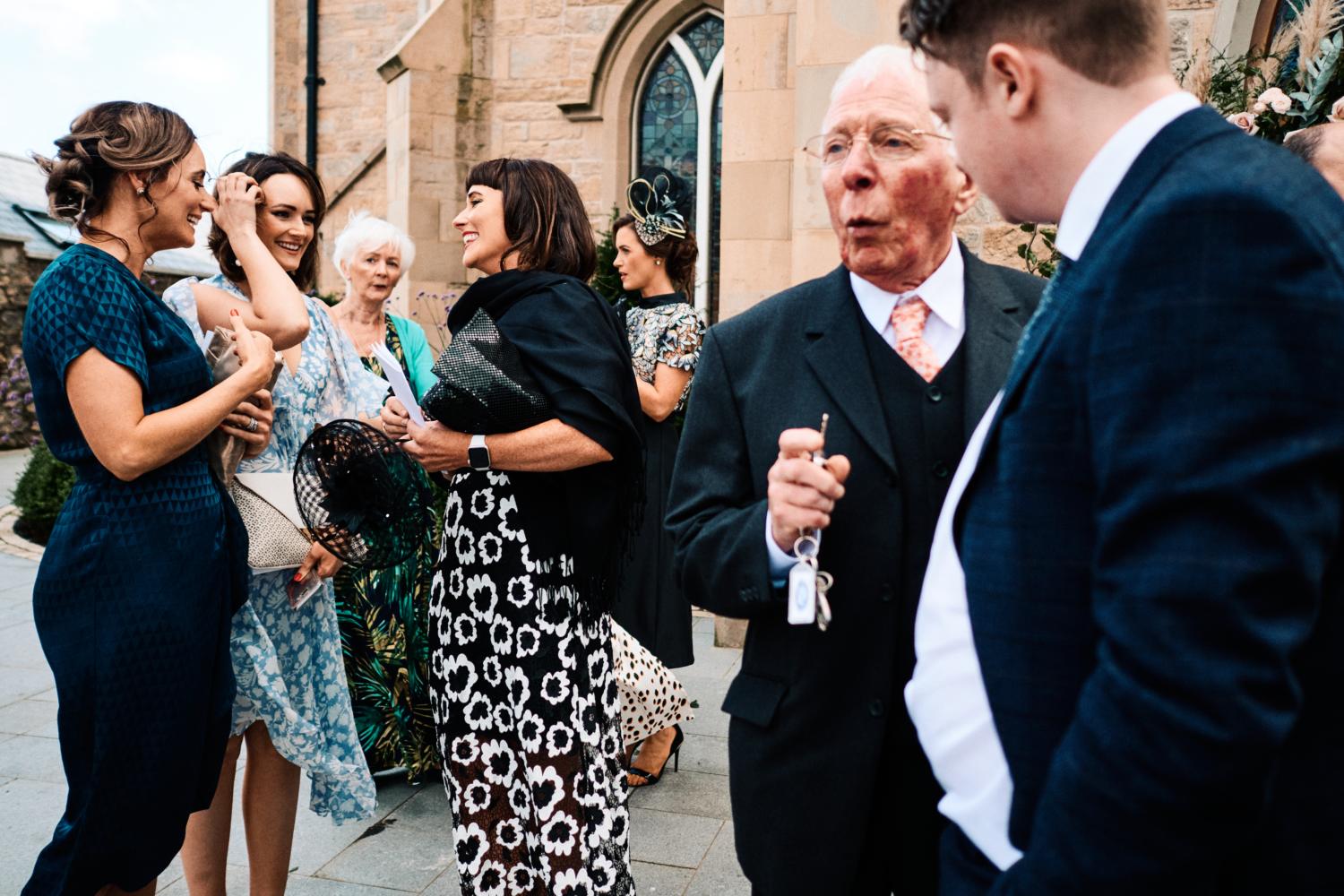 Friends and relatives talking outside a church